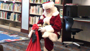 Santa tells students what he has in his bag.