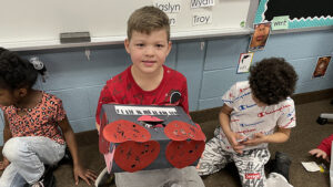 A kindergarten student shows his Valentine's Day box.