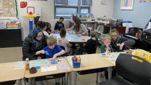 First graders and their guests play their math games.